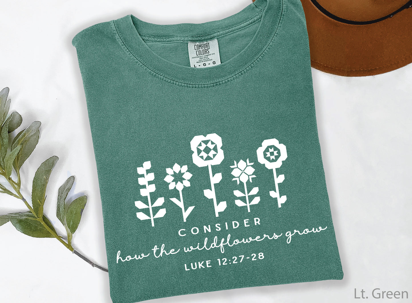 Quilt-inspired wildflower design t-shirt featuring Bible verse Luke 12:27–28, perfect for quilters and faith-based apparel.