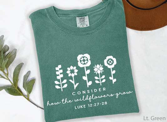 Quilt-inspired wildflower design t-shirt featuring Bible verse Luke 12:27–28, perfect for quilters and faith-based apparel.