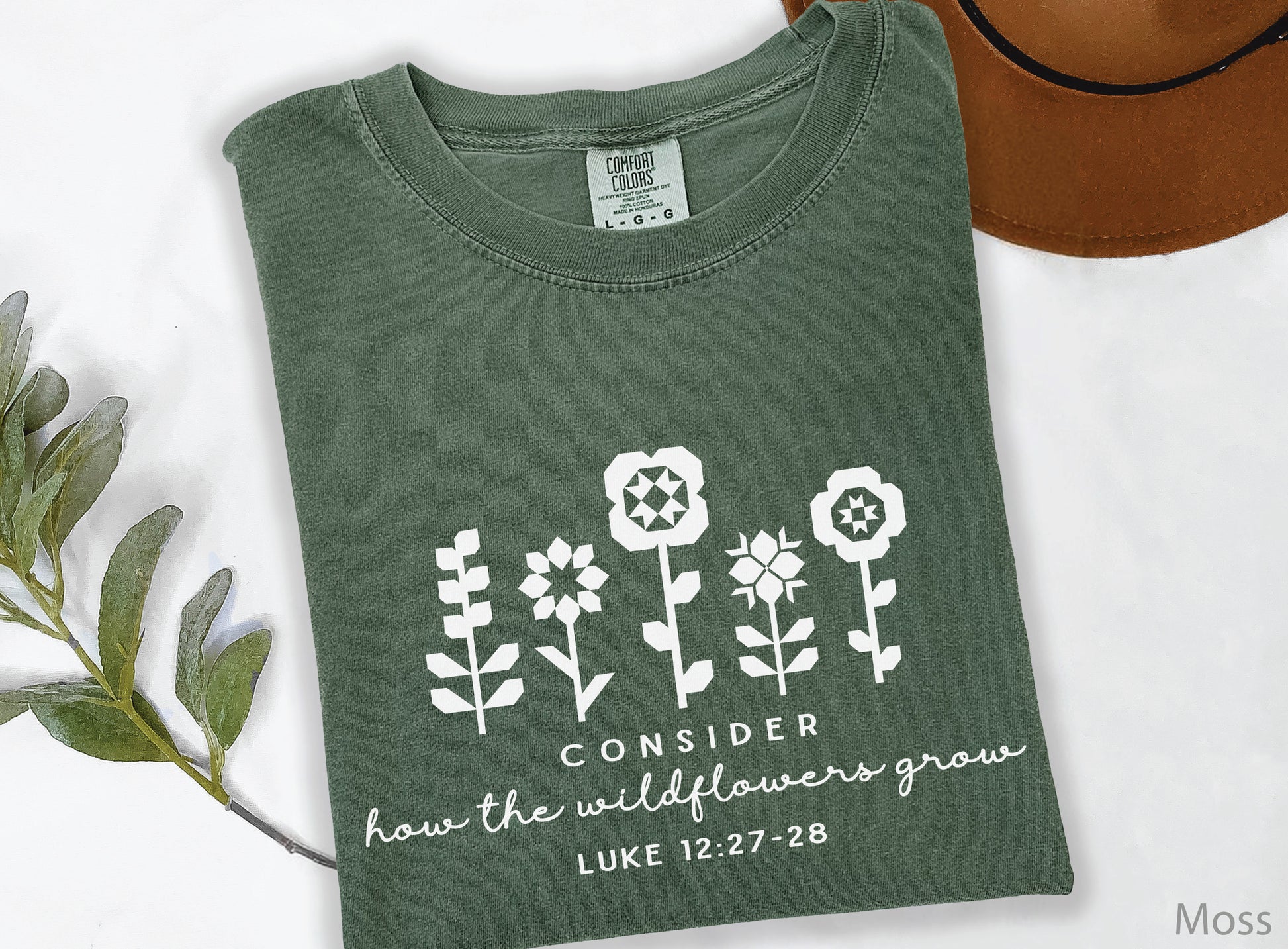 Quilt-inspired wildflower design t-shirt featuring Bible verse Luke 12:27–28, perfect for quilters and faith-based apparel.