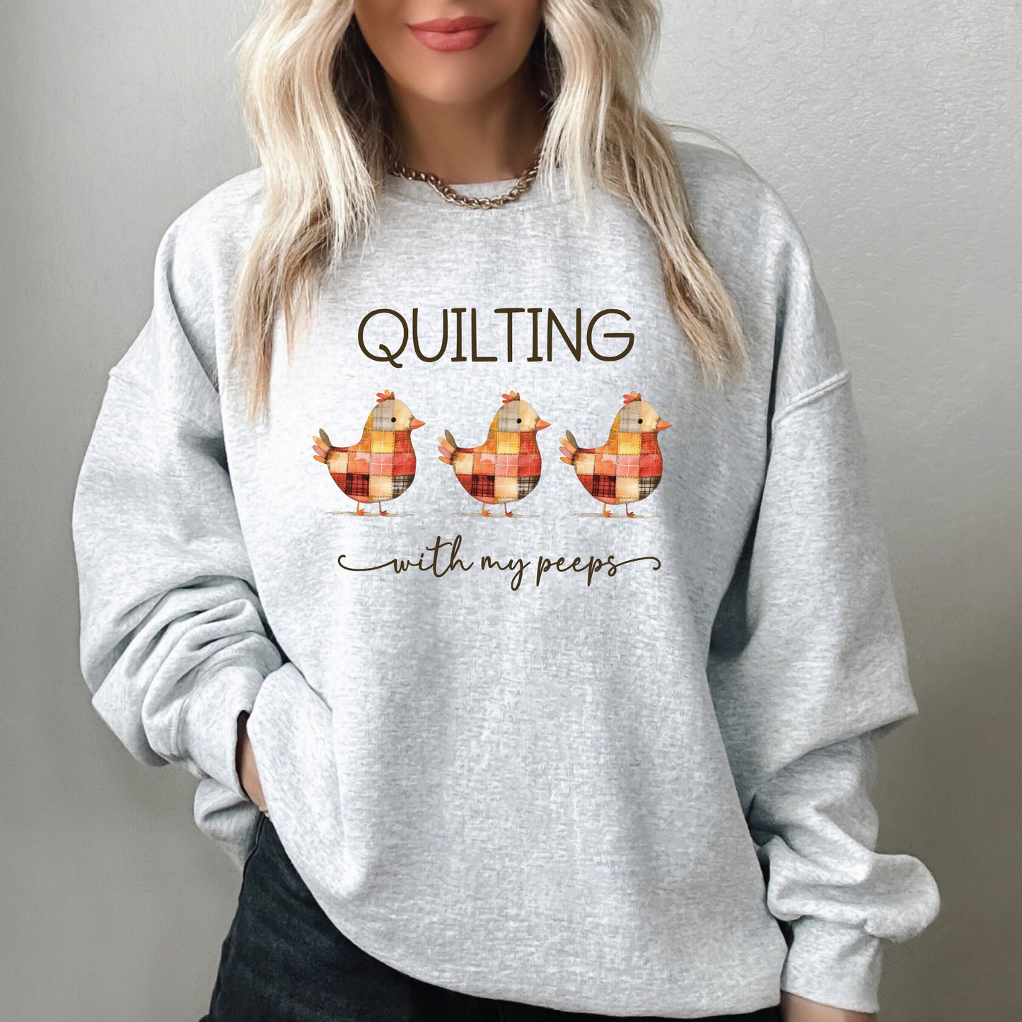 Quilting With My Peeps sweatshirt featuring colorful patchwork baby chicks, a fun gift for quilters and sewists from Bee Inspired Tees—perfect for retreats, sewing days, and cozy everyday wear.