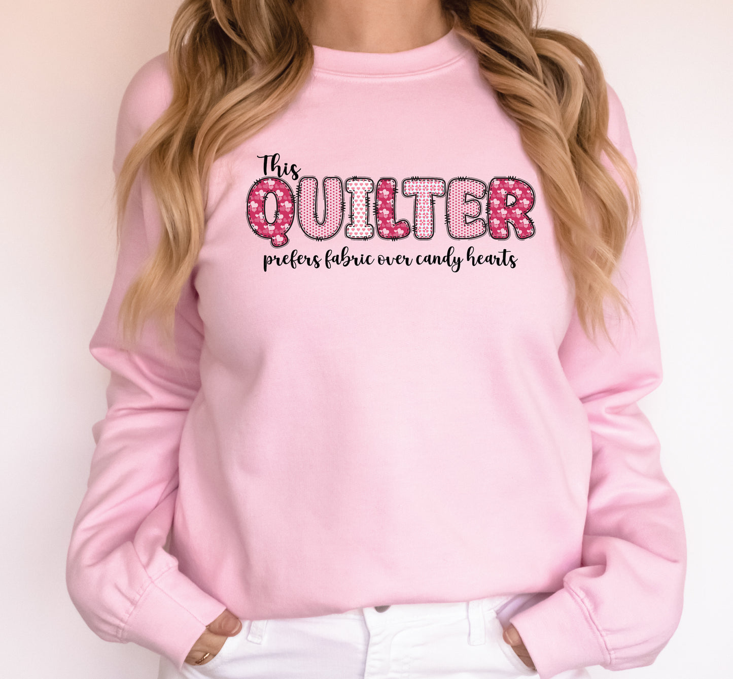 Valentine’s Day quilting t-shirt with the phrase “This Quilter Prefers Fabric Over Candy” in patchwork-style lettering, perfect for quilters.