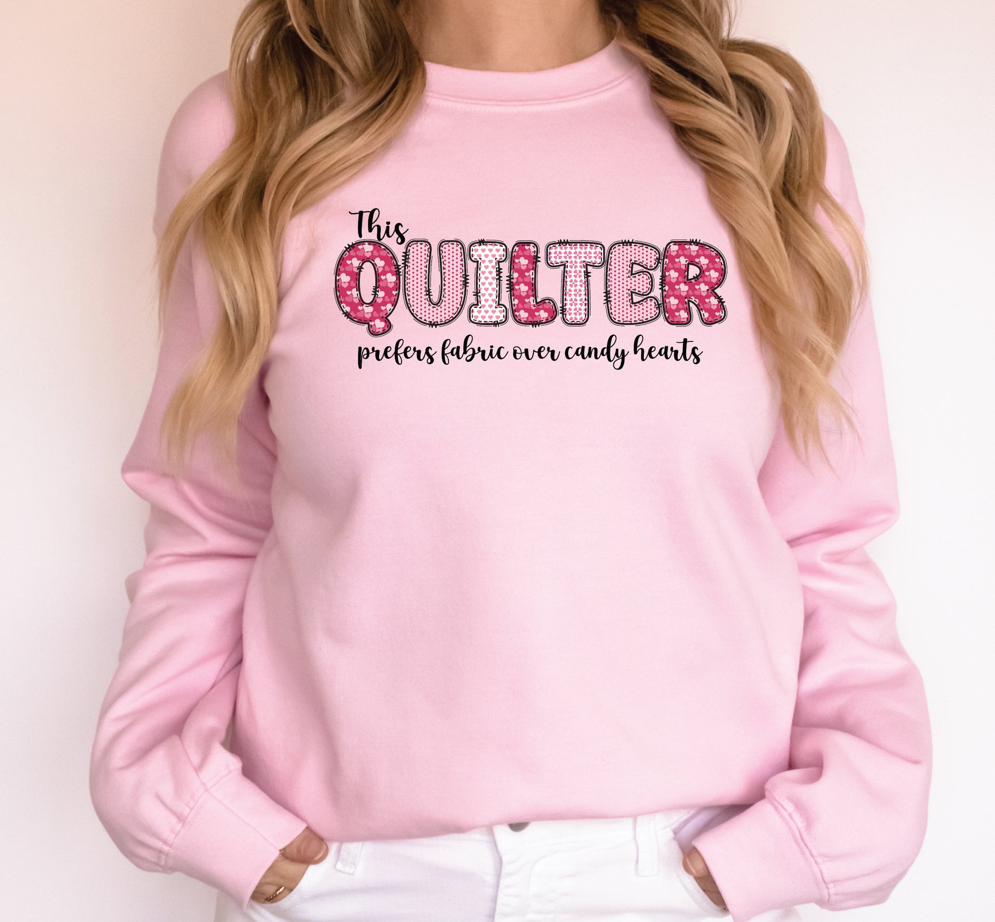 Valentine’s Day quilting t-shirt with the phrase “This Quilter Prefers Fabric Over Candy” in patchwork-style lettering, perfect for quilters.