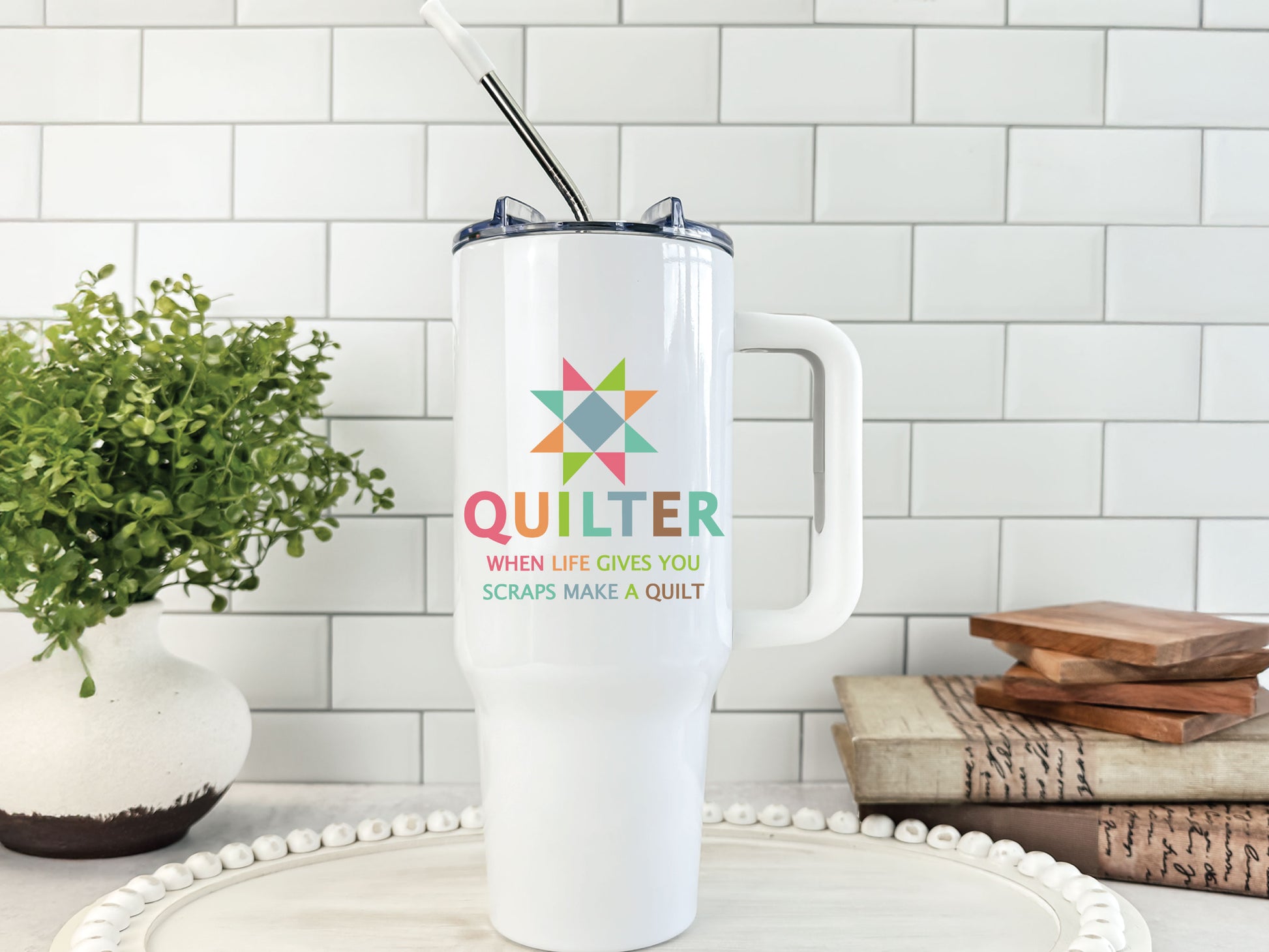 40oz handled tumbler featuring a bright quilt block star, the phrase “Quilter — When Life Gives You Scraps, Make a Quilt,” and colorful quilt blocks on the opposite side, personalize with name.