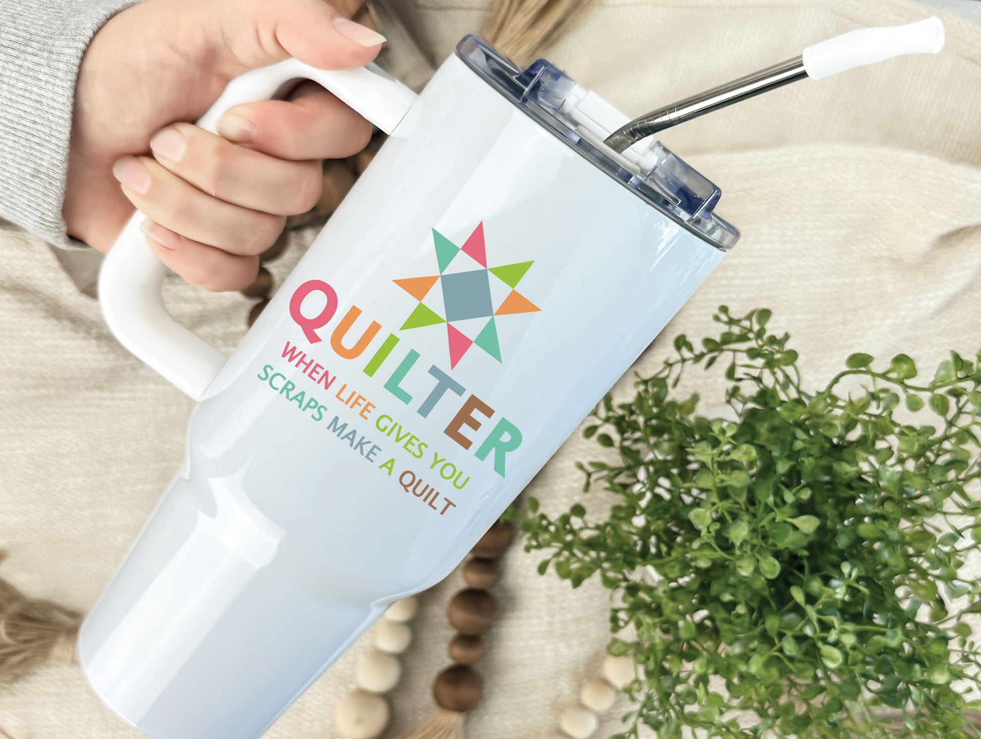 40oz handled tumbler featuring a bright quilt block star, the phrase “Quilter — When Life Gives You Scraps, Make a Quilt,” and colorful quilt blocks on the opposite side, personalize with name.