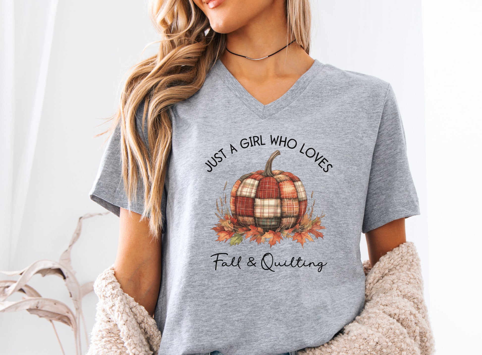 Just a Girl Who Loves Fall & Quilting t-shirt featuring a plaid pumpkin surrounded by colorful autumn leaves, designed for quilters who love cozy fall sewing, quilt retreats, and pumpkin spice season.
