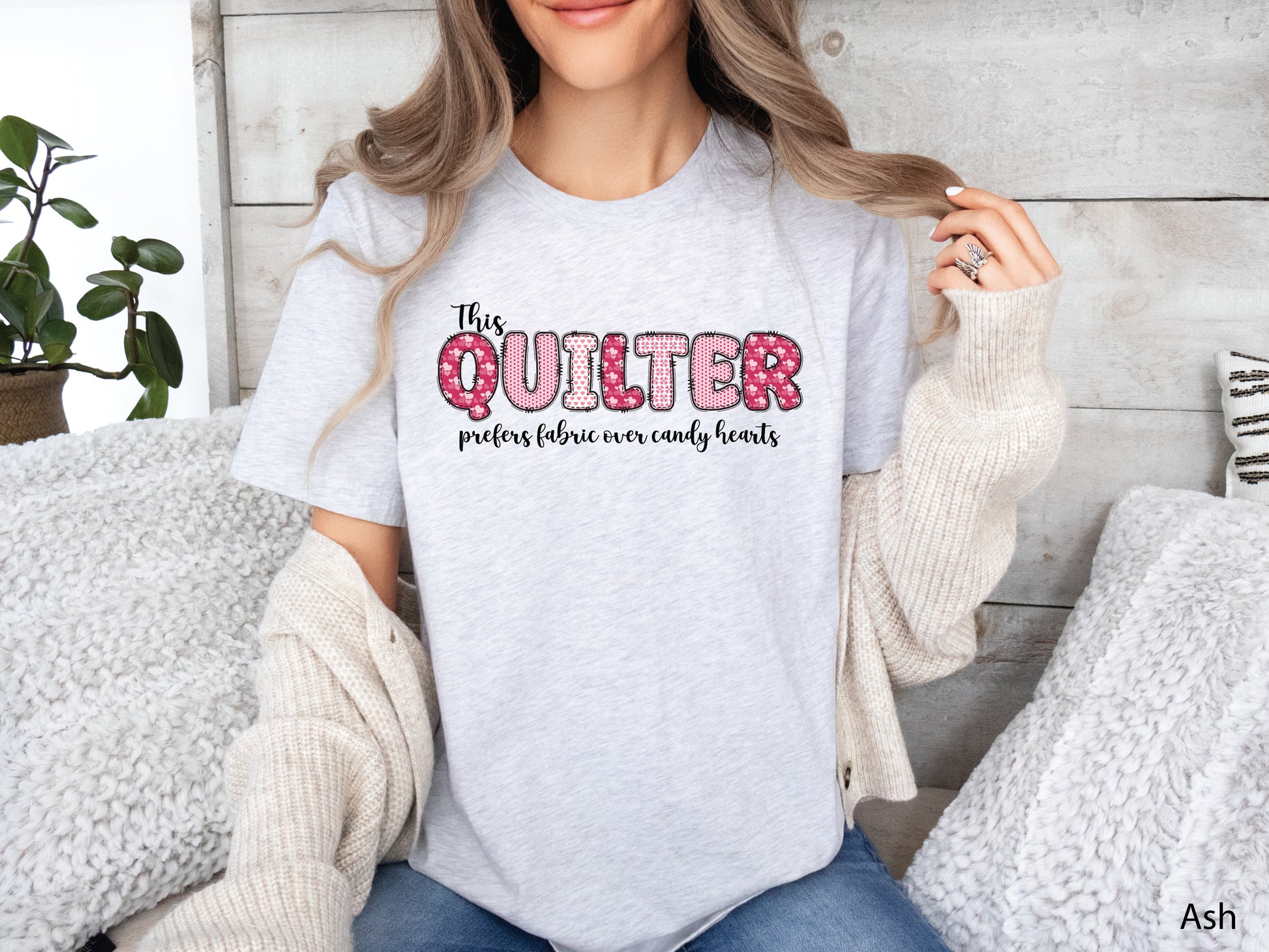 Valentine’s Day quilting t-shirt with the phrase “This Quilter Prefers Fabric Over Candy” in patchwork-style lettering, perfect for quilters.