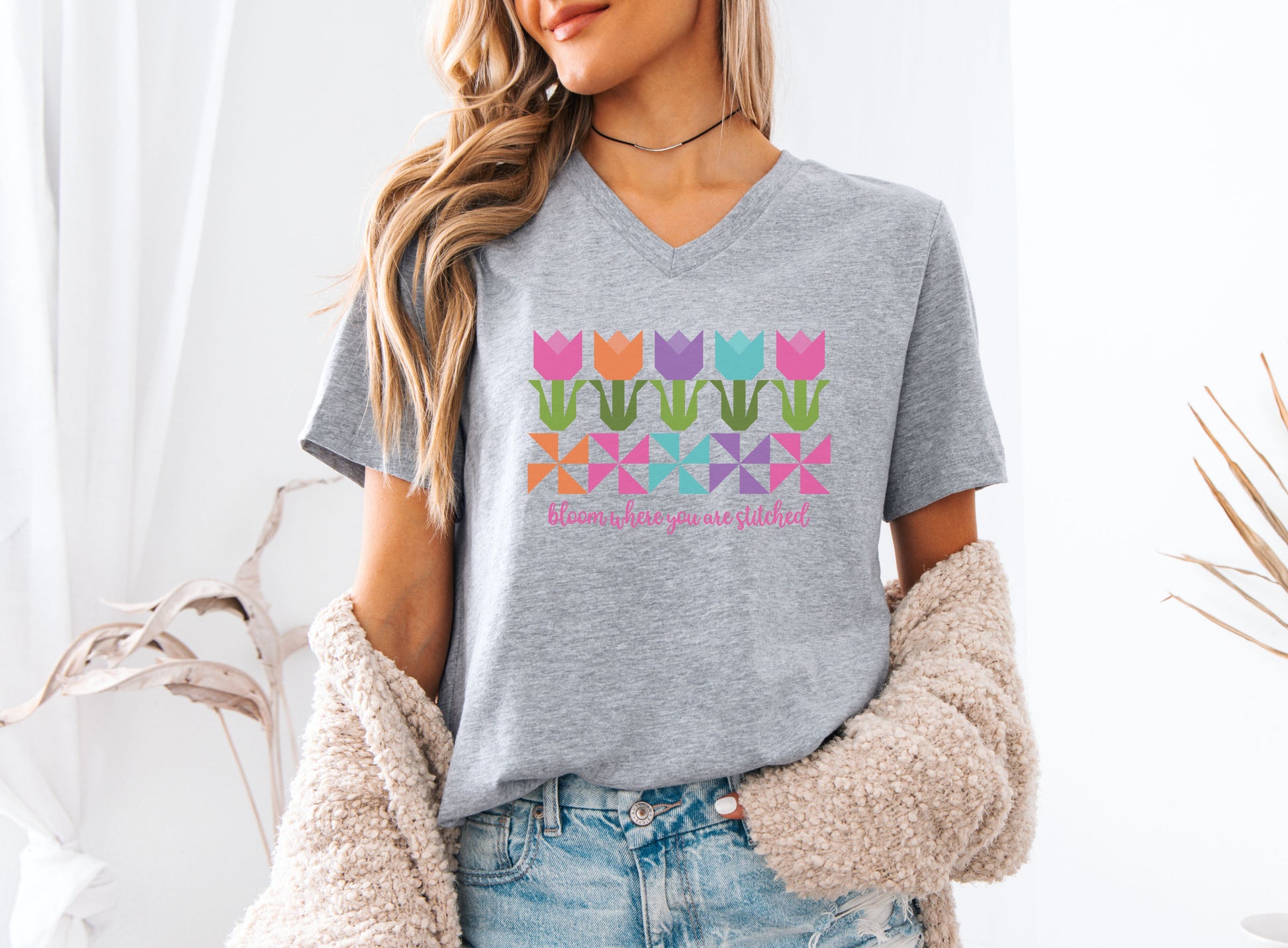 Bloom wherever you go with this quilt tulip v-neck tee featuring colorful patchwork blocks and “Bloom Where You Are Stitched”—perfect for quilters and sewists.