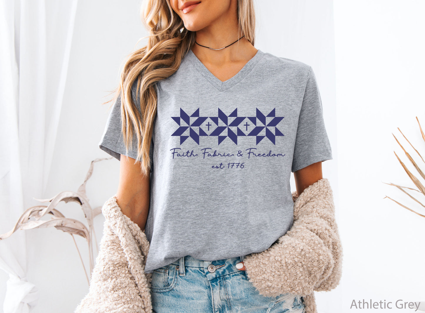 Faith, Fabric & Freedom patriotic v-neck t-shirt with quilt block stars and cross details. Perfect for quilters, sewists, and faith-based gifts.