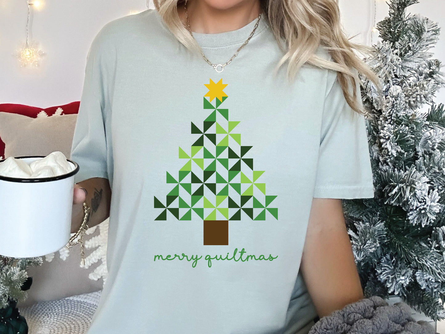 Merry Quiltmas t-shirt in Bay (light green) with quilt block Christmas tree design in green pinwheel blocks topped with gold star—holiday gift for quilters. Shop at Bee Inspired Tees for sewing and quilt-themed short and long sleeve t-shirts, gifts, and stickers designed for passionate sewists and quilters.