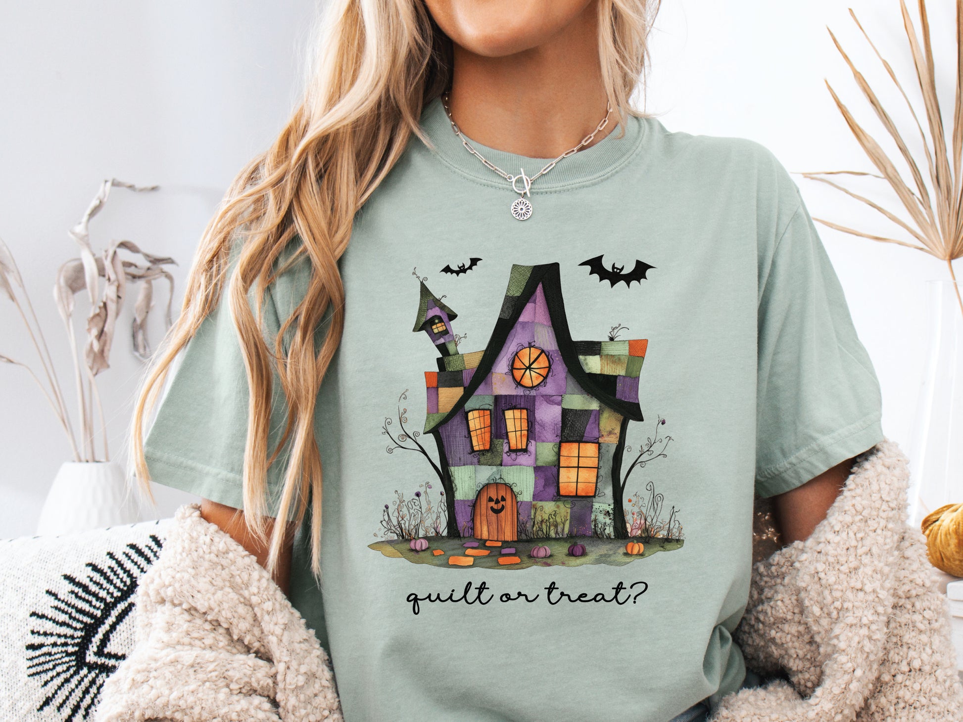 Quilt or Treat Halloween t-shirt on a Comfort Colors Bay (green) tee—fun Halloween gift for quilters, perfect for spooky season sewing and retreats.