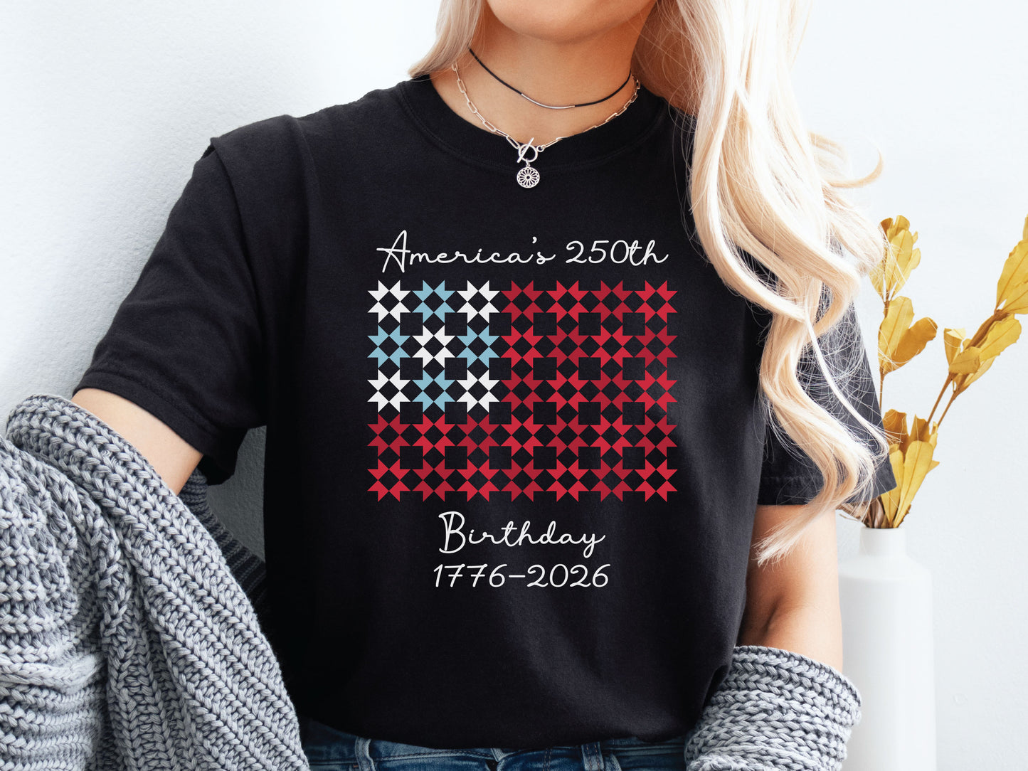 Patriotic quilting t-shirt featuring red, white, and blue quilt blocks with “Quiltin’ USA” design celebrating America’s 250th Birthday, printed on a Comfort Colors shirt.