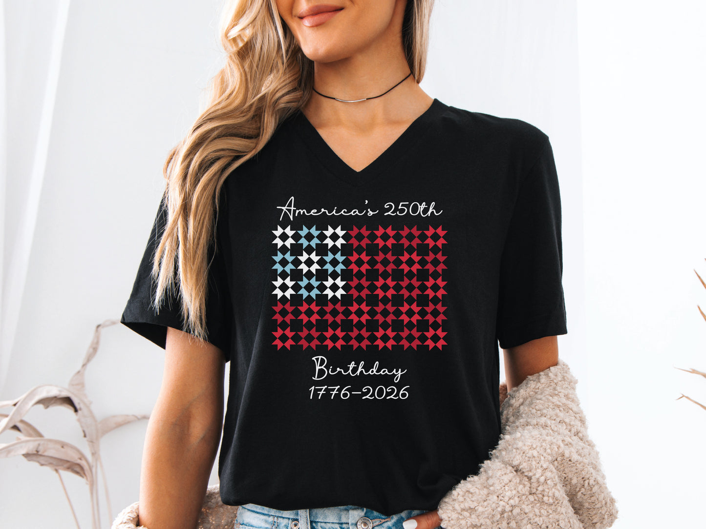 Celebrate America’s 250th Birthday with this “Quiltin’ USA” patriotic quilting v-neck tee shirt. Featuring red, white, and blue quilt blocks with a commemorative Americana design.