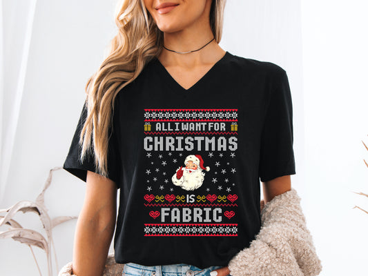 V-neck t-shirt with vintage Santa and stitch-style “All I Want for Christmas Is Fabric” design — fun holiday gift for quilters and sewing lovers.