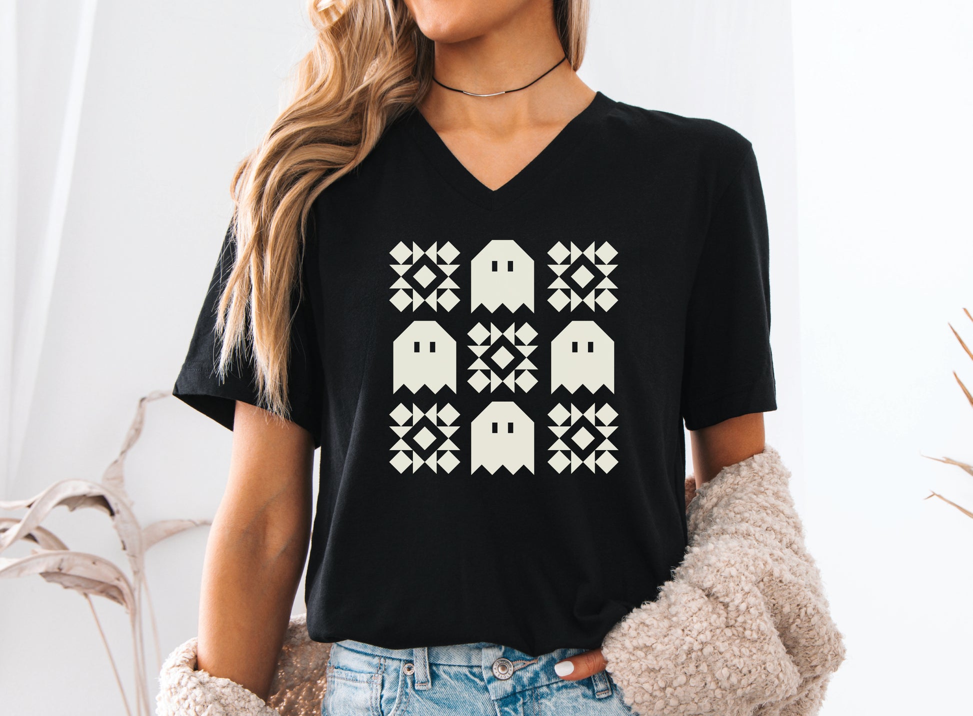 Soft Bella + Canva V-neck Halloween quilting t-shirt featuring a cream grid design with four spooky ghosts and five geometric quilt blocks. A customer favorite!