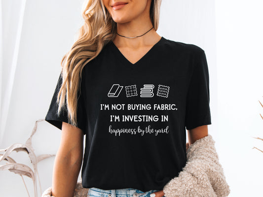 Sewing-themed V-neck t-shirt with the phrase “I’m Not Buying Fabric, I’m Investing in Happiness by the Yard,” perfect for sewists and fabric lovers.