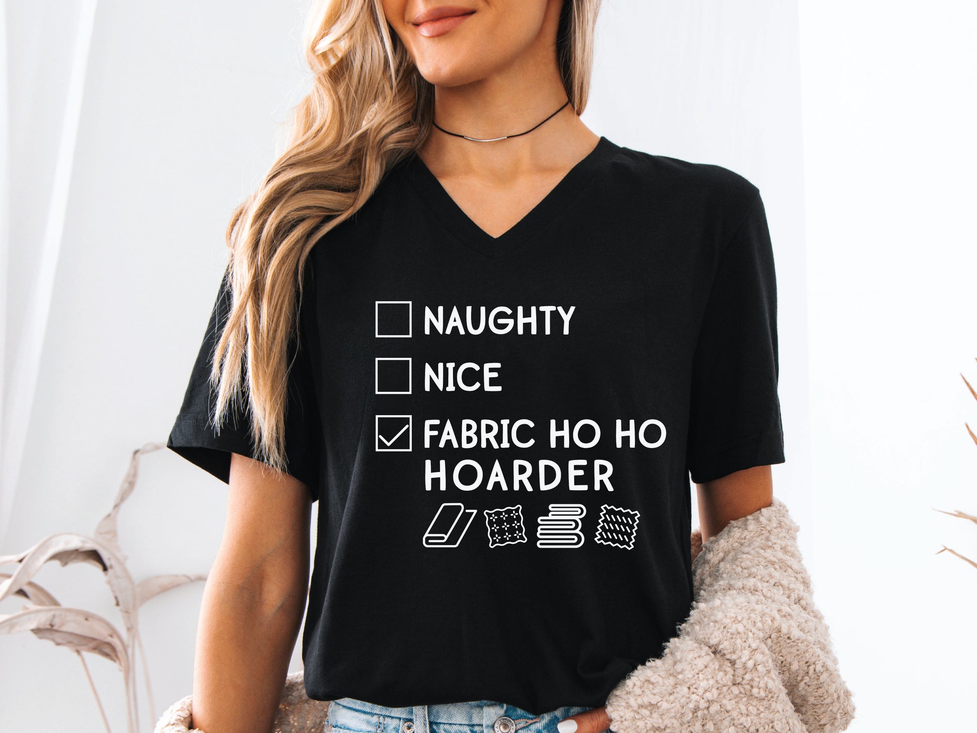Holiday V-neck t-shirt with a playful “Fabric Ho Ho Hoarder” checklist design and festive icons — fun Christmas gift for quilters, sewists, and fabric lovers.