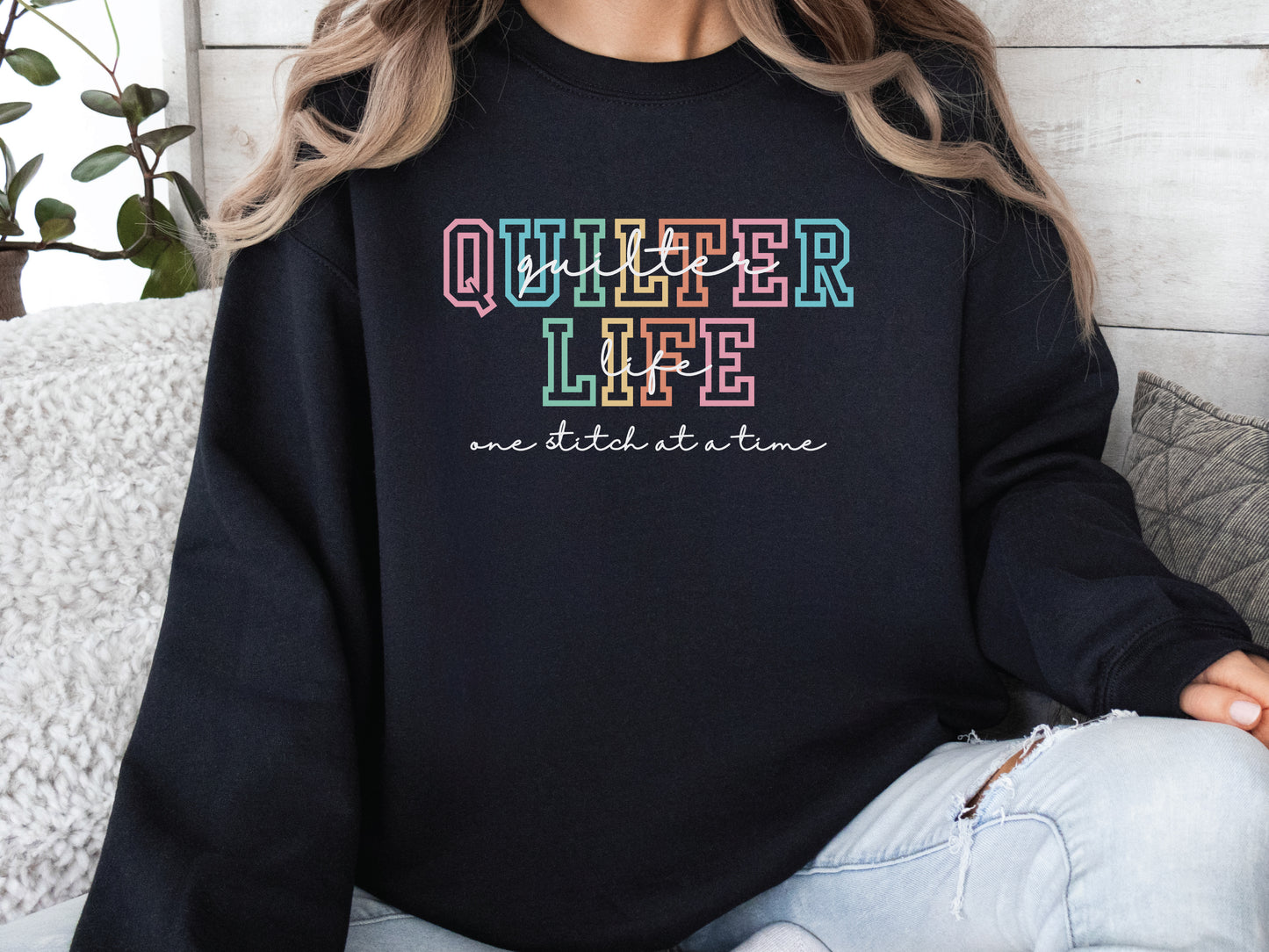 Sweatshirt with varsity-style lettering that reads “Quilter Life: One Stitch at a Time” — cozy and creative gift for quilters and sewing enthusiasts.