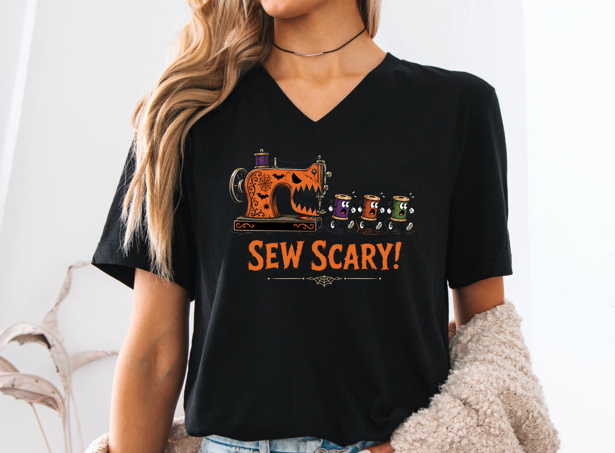 Sew Scary Halloween T-shirt with a vintage sewing machine monster chasing colorful thread spools, surrounded by bats and spiderwebs.