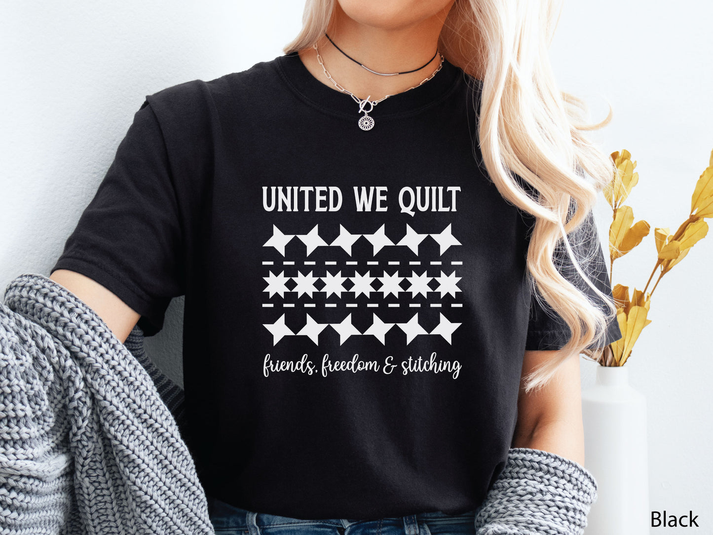 United We Quilt t-shirt with rows of friendship quilt blocks and the phrase Friends, Freedom & Stitching, a fun patriotic shirt for quilters and sewists.
