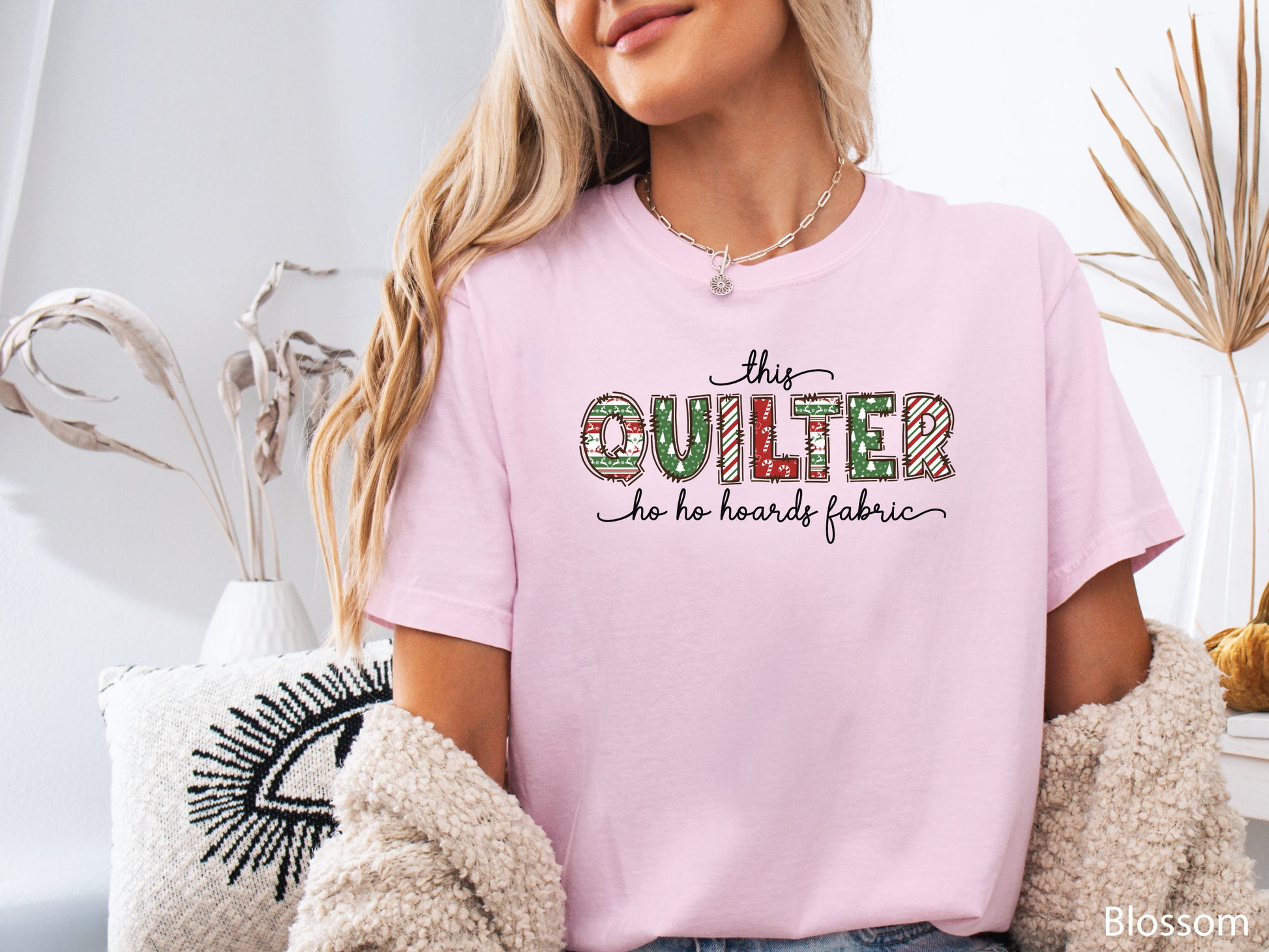 This Quilter Ho Ho Hoards Fabric t-shirt with red and green patchwork lettering, a funny Christmas shirt for quilters who love fabric, sewing, and holiday cheer.