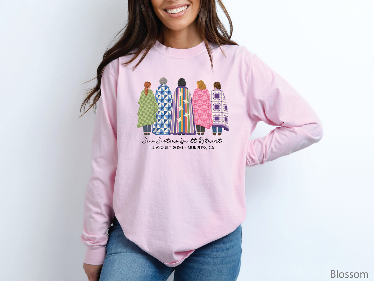 Sew Sisters Quilt Retreat long-sleeved shirt design featuring five women wrapped in colorful green, blue, striped, pink heart, and purple quilts with LUV2QUILT 2026 personalized text.