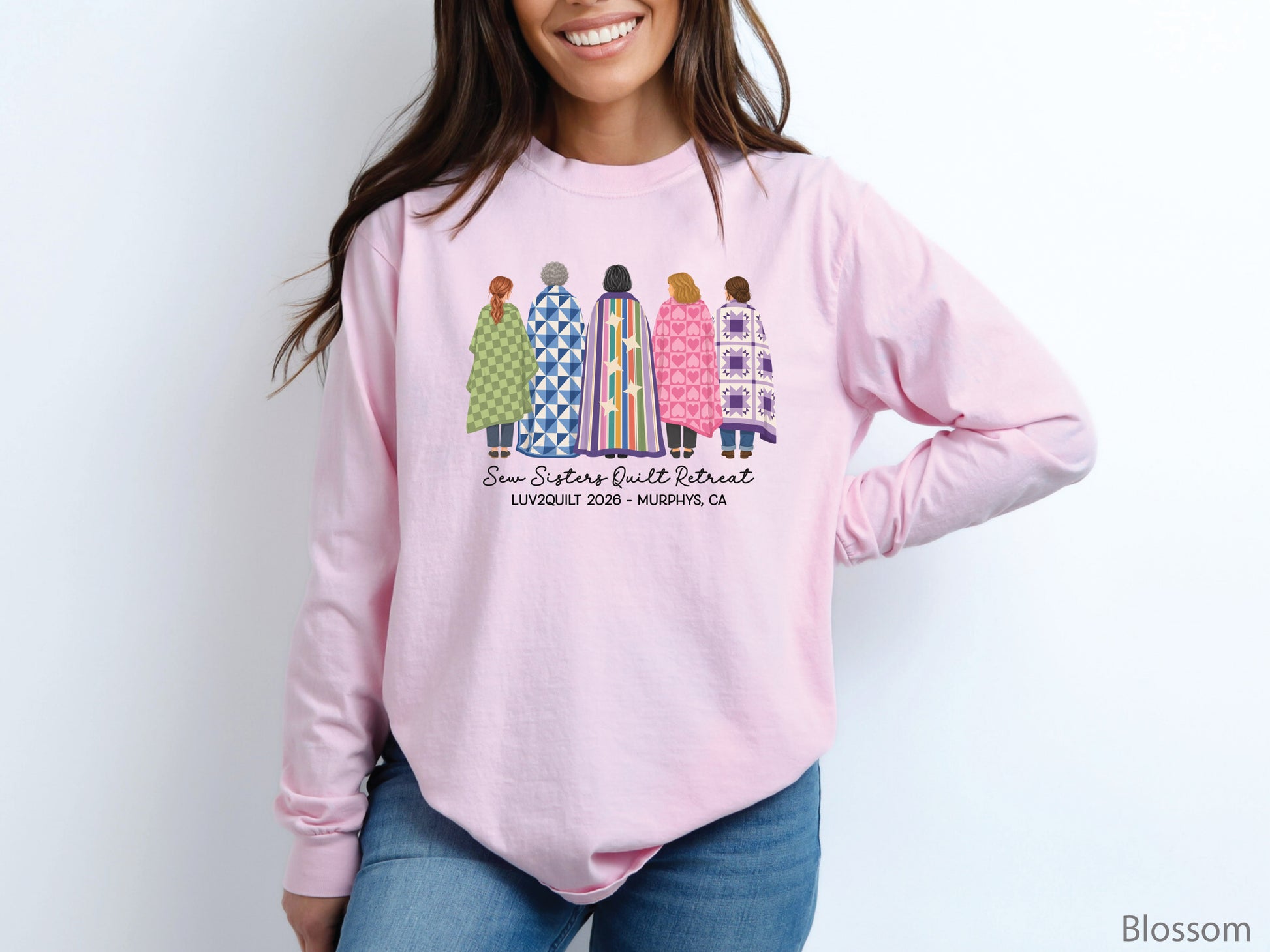 Sew Sisters Quilt Retreat long-sleeved shirt design featuring five women wrapped in colorful green, blue, striped, pink heart, and purple quilts with LUV2QUILT 2026 personalized text.