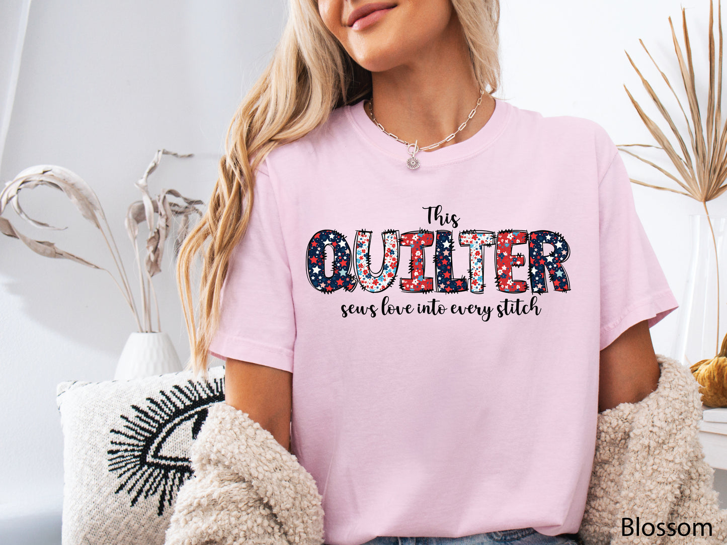 Patriotic quilting t-shirt with the phrase “This Quilter Sews Love Into Every Stitch” in red, white, and blue patchwork lettering, perfect for celebrating America’s 250th Anniversary.