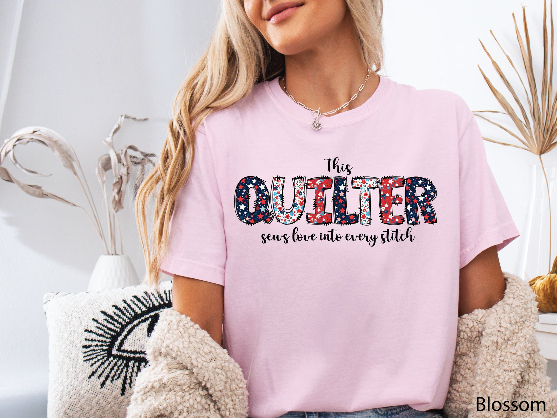 Patriotic quilting t-shirt with the phrase “This Quilter Sews Love Into Every Stitch” in red, white, and blue patchwork lettering, perfect for celebrating America’s 250th Anniversary.