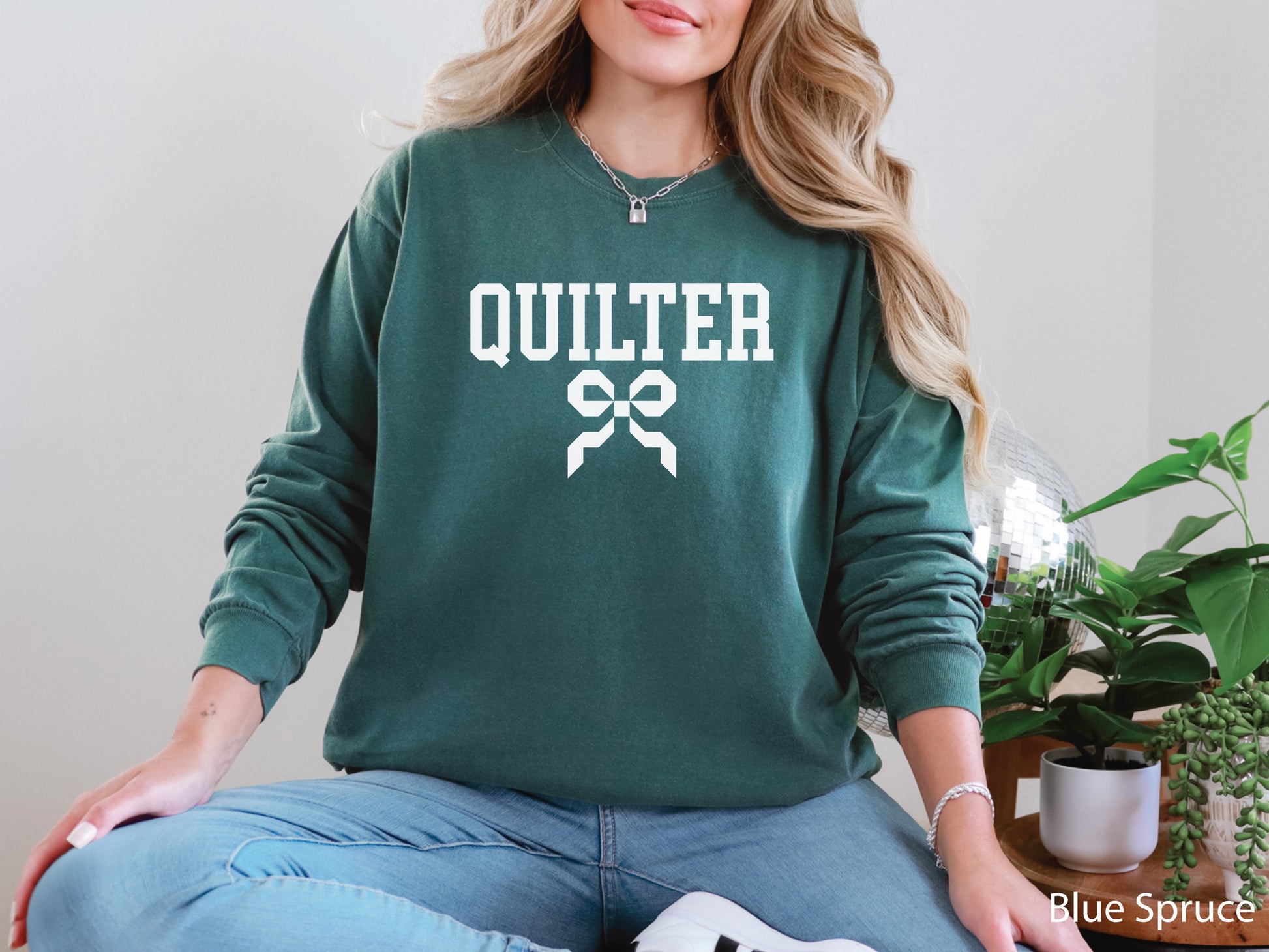 Cozy sweatshirt with bold varsity-style “Quilter” lettering and a coquette bow — perfect for quilt retreats, guild meetings, or as a thoughtful gift for quilters.