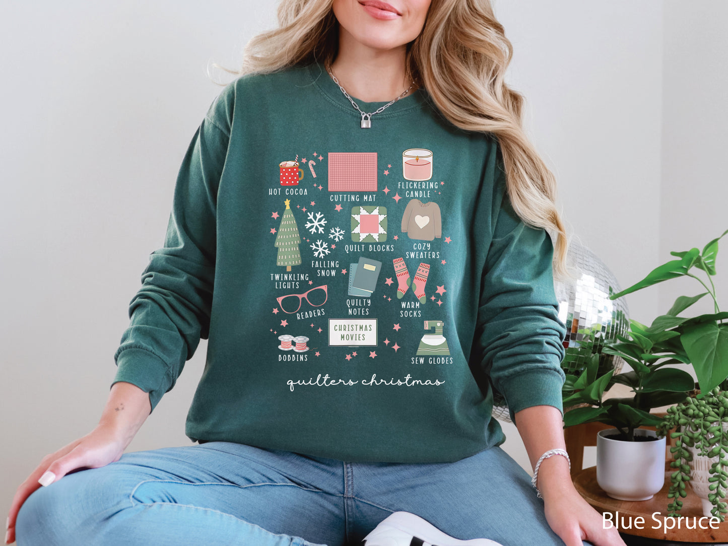 T-shirt with festive “Quilter’s Christmas” icons including quilt blocks, cocoa, lights, sweaters, and sewing items — perfect holiday gift for quilters and sewing lovers.