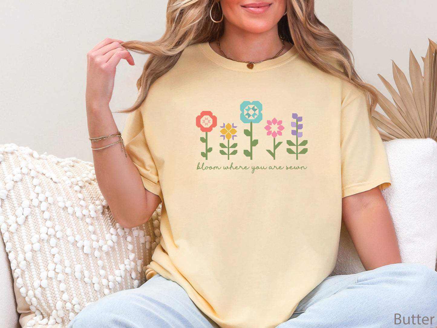 Yellow (Butter) t-shirt featuring colorful quilt block flowers with green stems and the phrase "Bloom Where You Are Sewn," perfect for quilters and sewing enthusiasts.