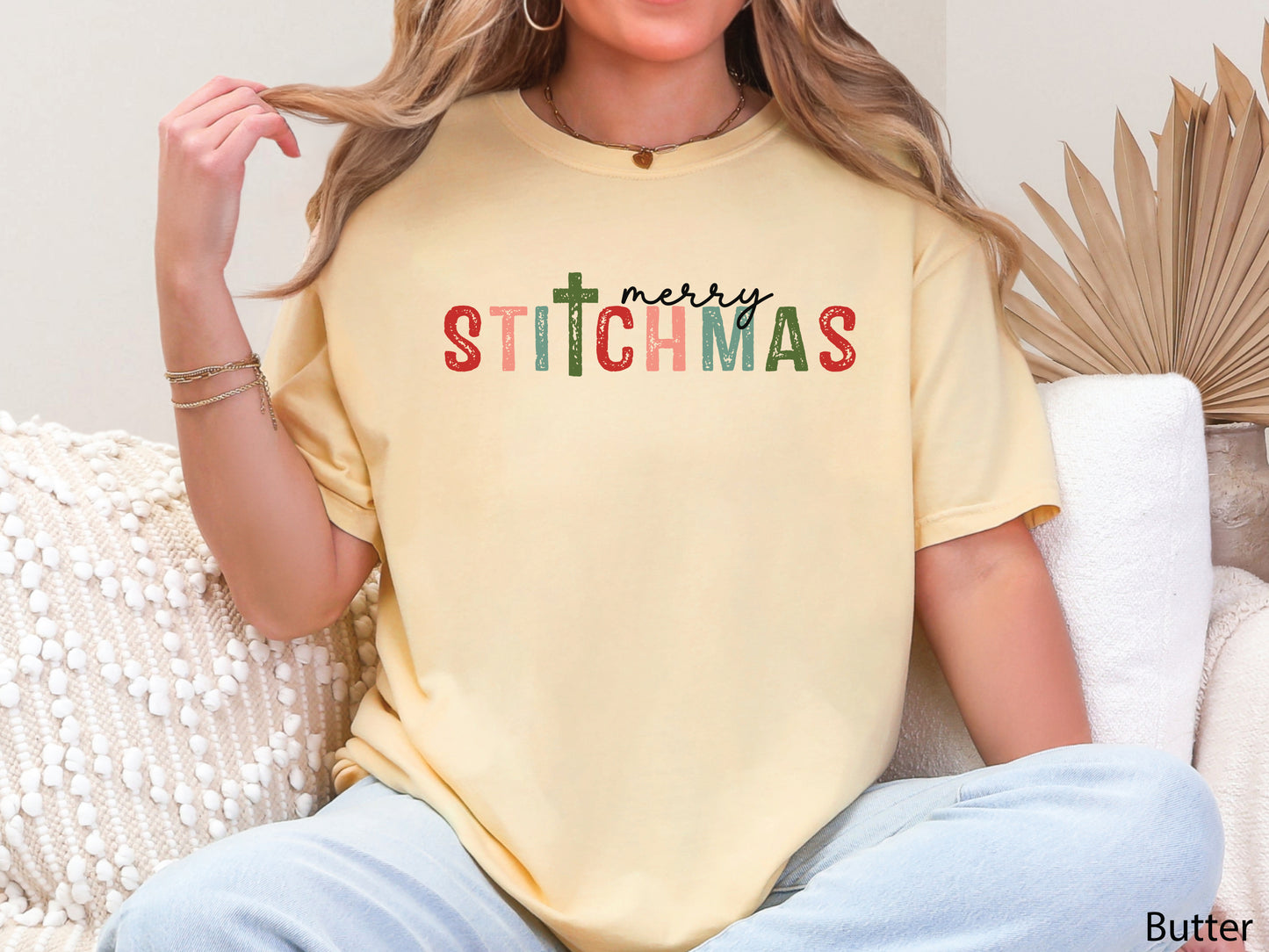 Merry Stitchmas t-shirt featuring the word STITCHMAS with a cross-shaped T, a festive holiday design for quilters, sewists, and makers who love stitching and faith.