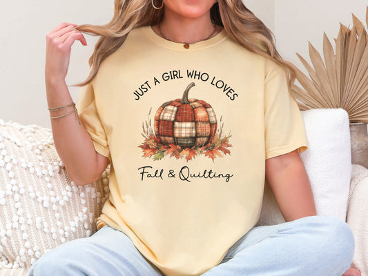 Light yellow (Butter) colored t-shirt from Bee Inspired Tees with the phrase “Just a Girl Who Loves Fall & Quilting,” featuring a plaid pumpkin surrounded by autumn leaves. Perfect fall gift for quilters and ideal for quilt retreats or sewing days.