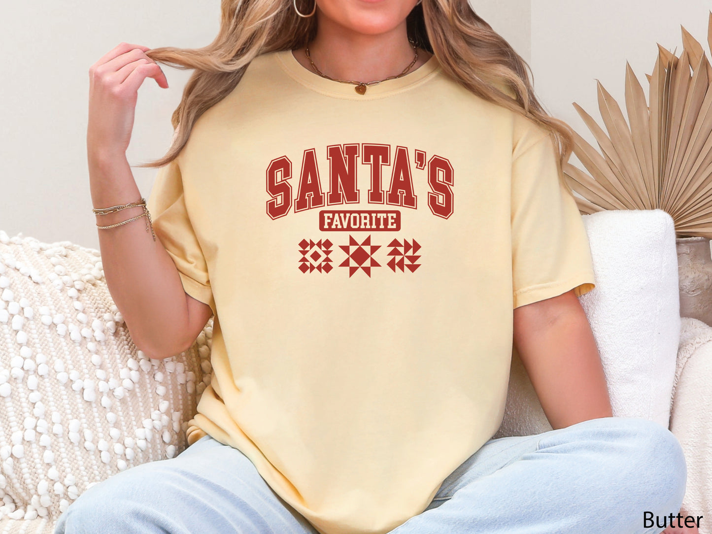 Festive yellow t-shirt with the phrase “Santa’s Favorite” in red varsity letters and three quilt block designs, styled for quilters who love Christmas and handmade gifts.