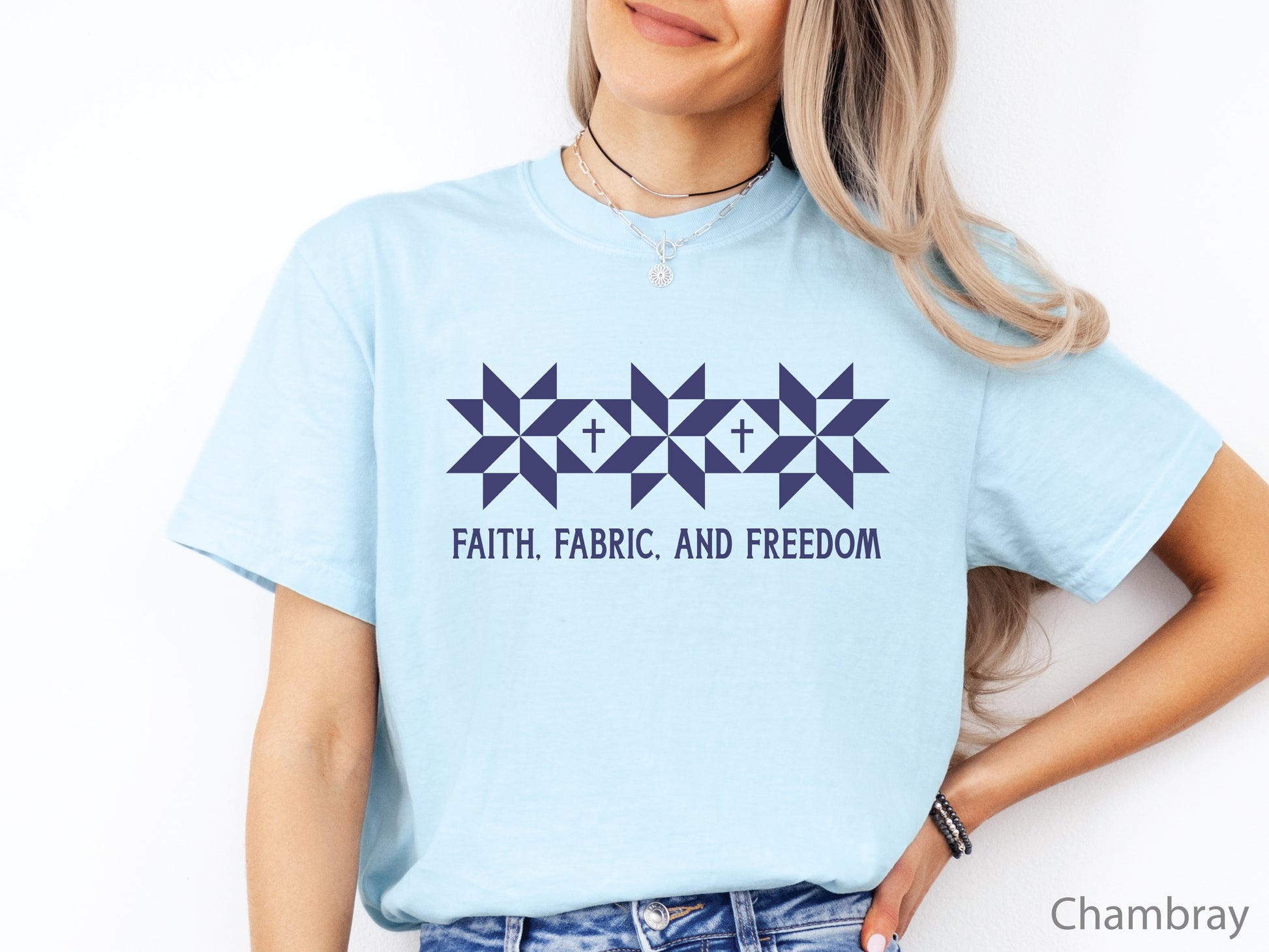 Blue t-shirt with Faith, Fabric & Freedom design featuring quilt star blocks with cross details, ideal for quilters and faith-based patriotic wear.