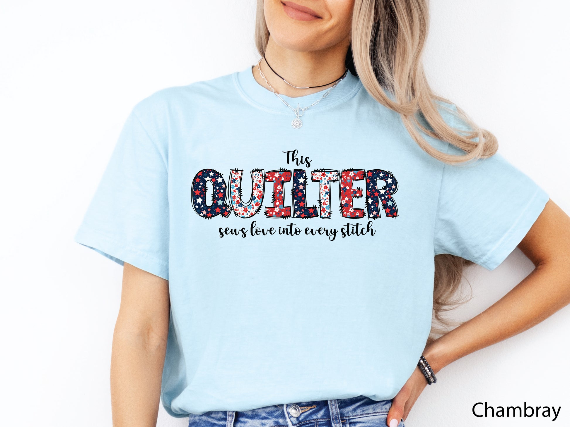 Patriotic quilting t-shirt with the phrase “This Quilter Sews Love Into Every Stitch” in red, white, and blue patchwork lettering, perfect for celebrating America’s 250th Anniversary.