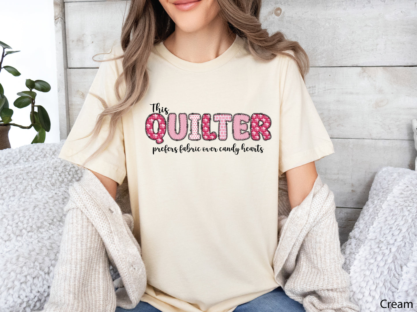 Valentine’s Day quilting t-shirt with the phrase “This Quilter Prefers Fabric Over Candy” in patchwork-style lettering, perfect for quilters.