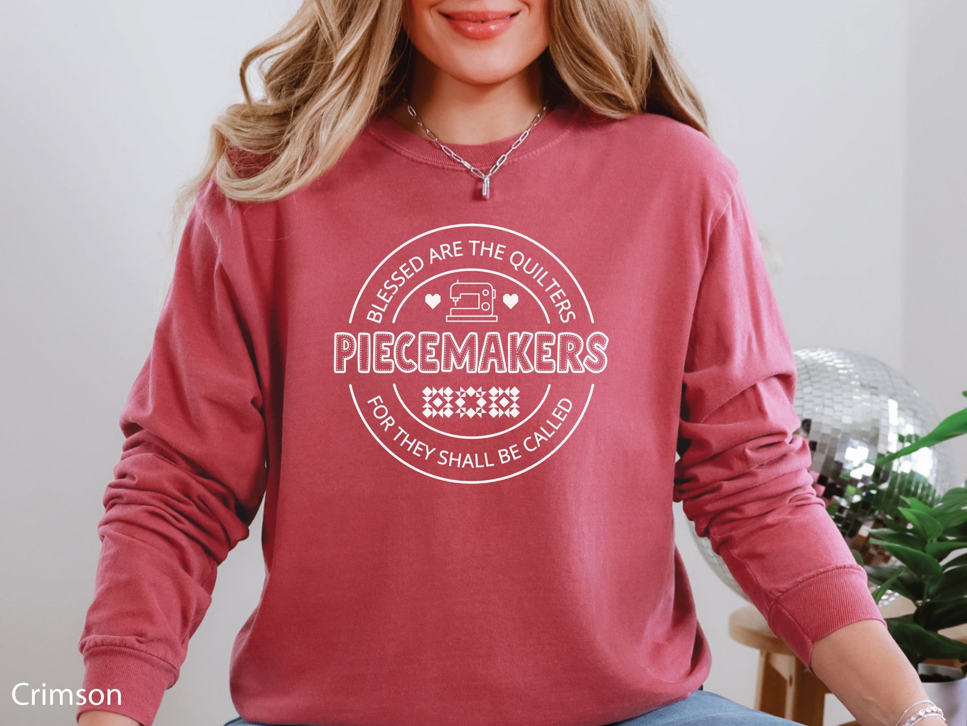 A long-sleeve quilting t-shirt from Bee Inspired Tees featuring the phrase “Piecemaker – Quilters Are Blessed,” celebrating creativity, faith, and the art of quilting; a cozy gift for quilters and perfect for retreats or sewing days.