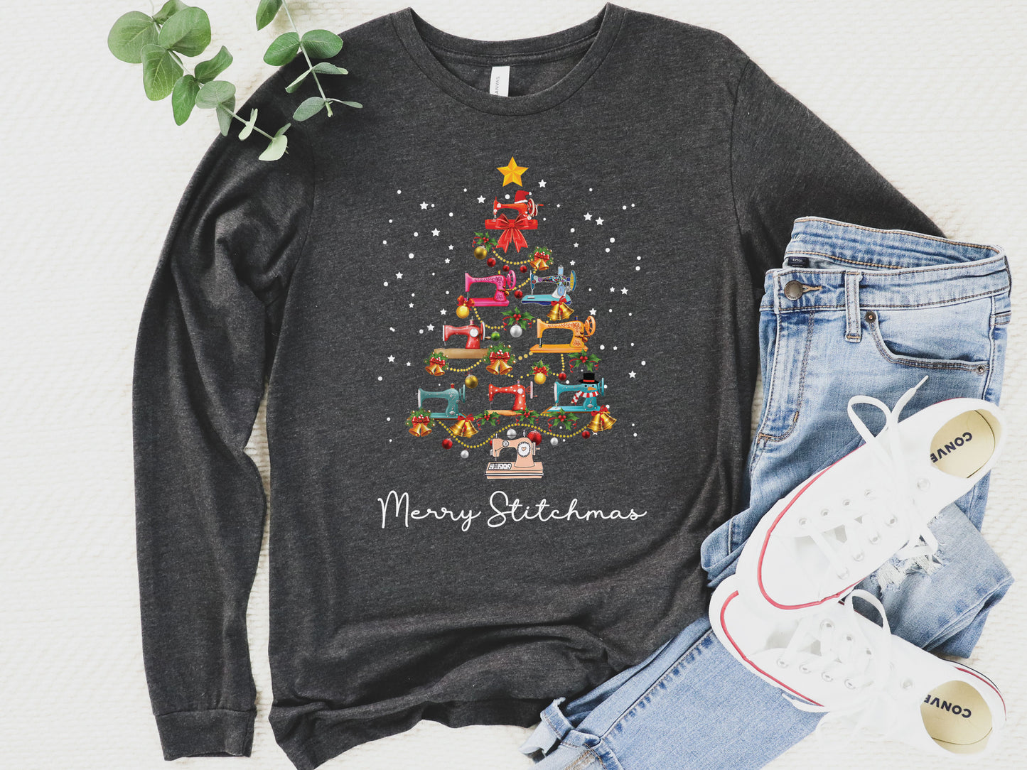 Dark grey long sleeve shirt with a Christmas tree made of colorful sewing machines and the words “Merry Stitchmas” — festive holiday gift for quilters and sewists.
