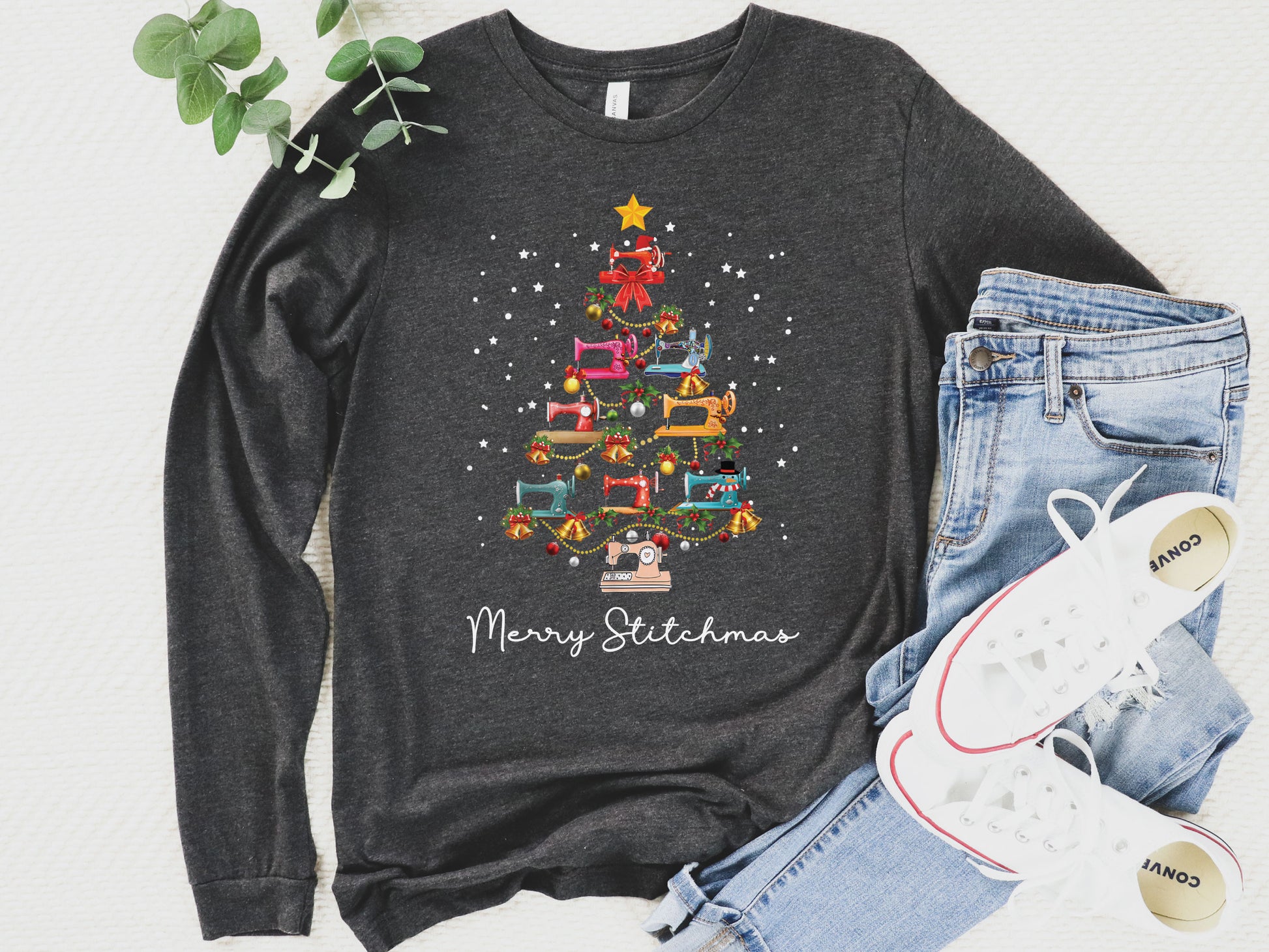 Dark grey long sleeve shirt with a Christmas tree made of colorful sewing machines and the words “Merry Stitchmas” — festive holiday gift for quilters and sewists.