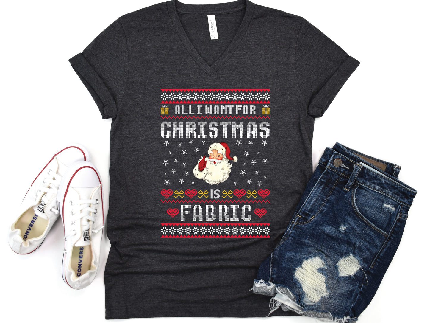 V-neck t-shirt with vintage Santa and stitch-style “All I Want for Christmas Is Fabric” design — fun holiday gift for quilters and sewing lovers.
