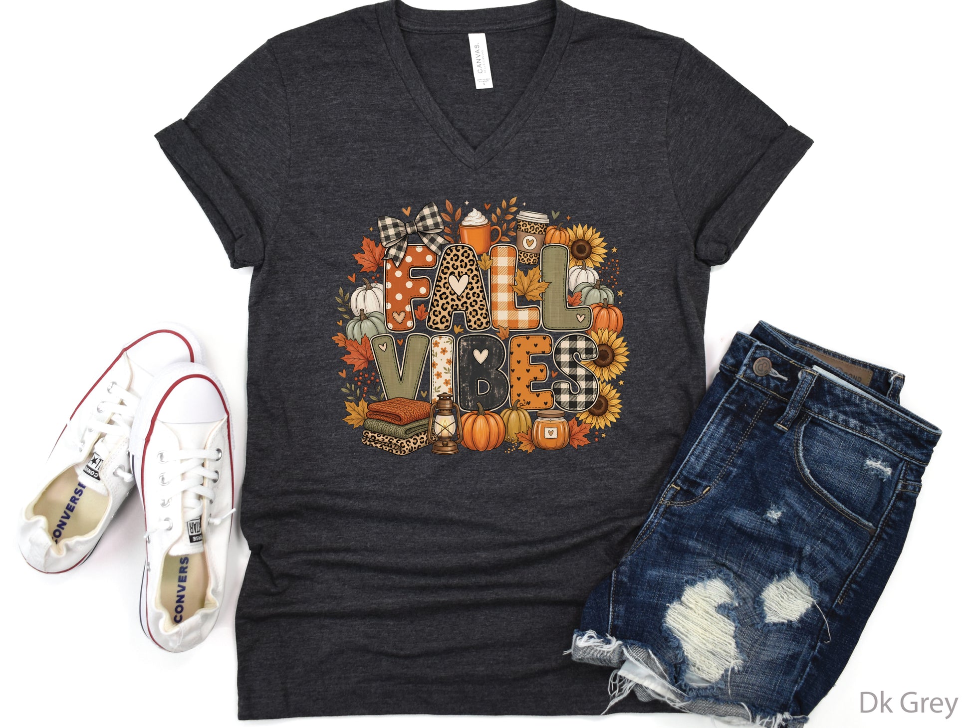 Fall Vibes t-shirt design with patchwork-style lettering, pumpkins, sunflowers, fall leaves, cozy drinks, lantern, candle, and folded blankets.