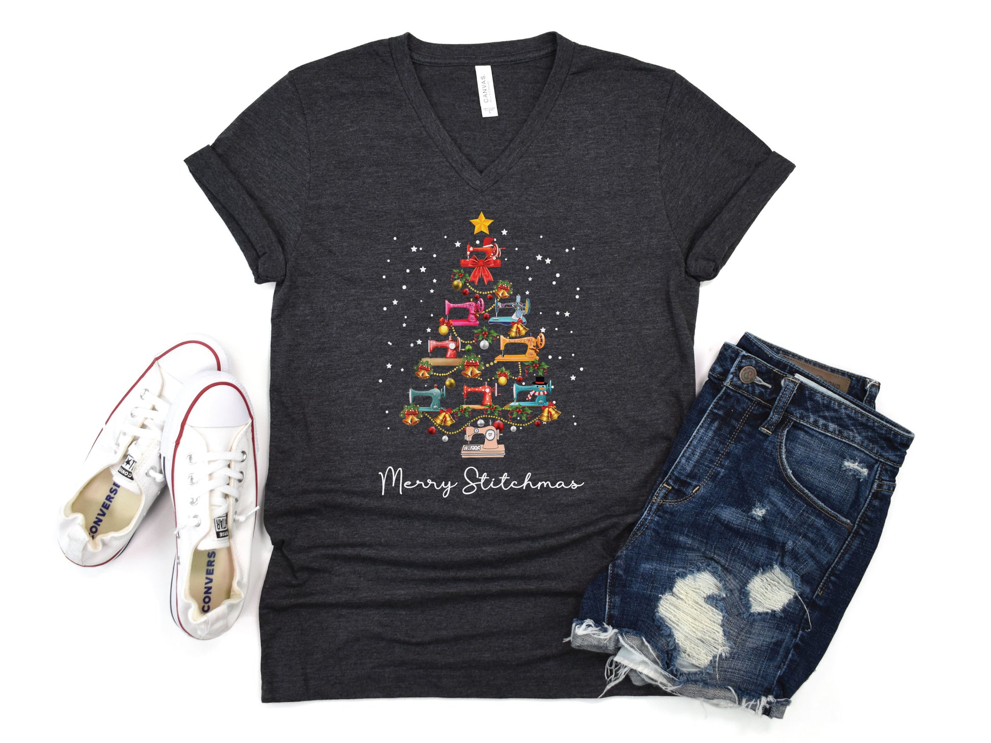 Festive Christmas tree made of colorful sewing machines with the phrase “Merry Stitchmas” on a V-neck t-shirt, a fun holiday gift for quilters and sewing enthusiasts.