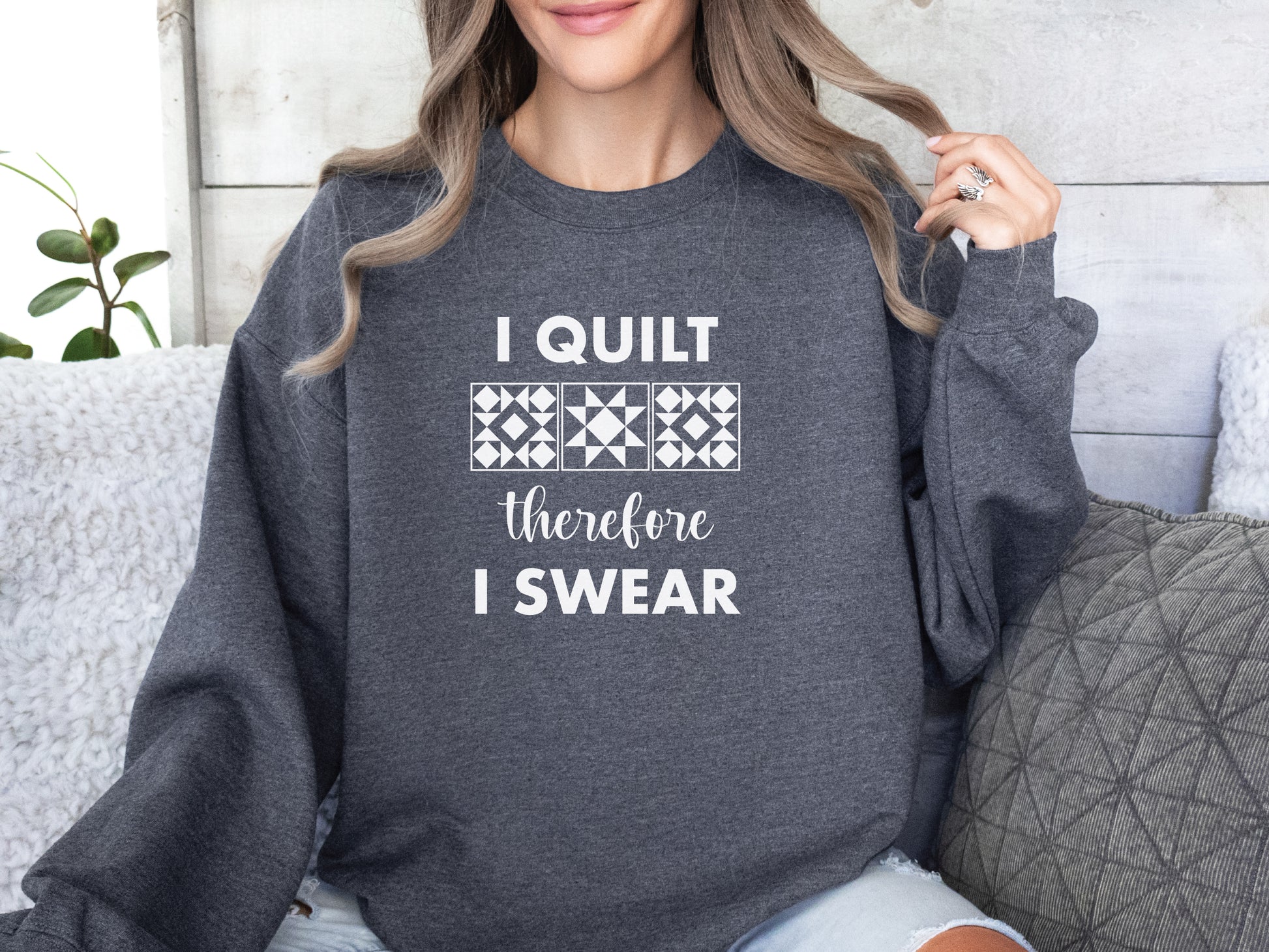 A cozy quilting sweatshirt from Bee Inspired Tees featuring the phrase “I Quilt, Therefore I Swear,” a funny and relatable gift for quilters who love to sew, laugh, and stay warm while stitching.