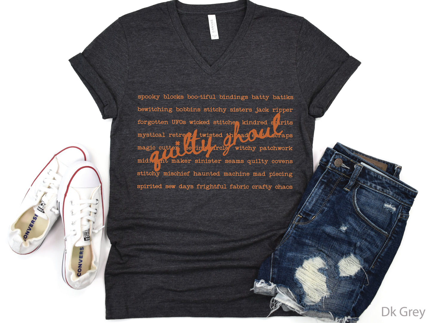 Quilty Ghoul Halloween t-shirt featuring vintage orange typography with playful quilting and spooky phrases in a word collage design on a black shirt.