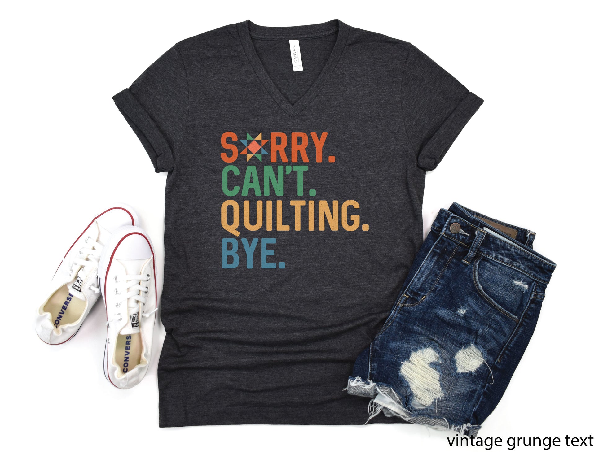 Funny “Sorry, Can’t. Quilting. Bye.” V-neck T-shirt with distressed vintage-style lettering, shown on a dark heather gray shirt — a humorous gift for sewing and quilting lovers.