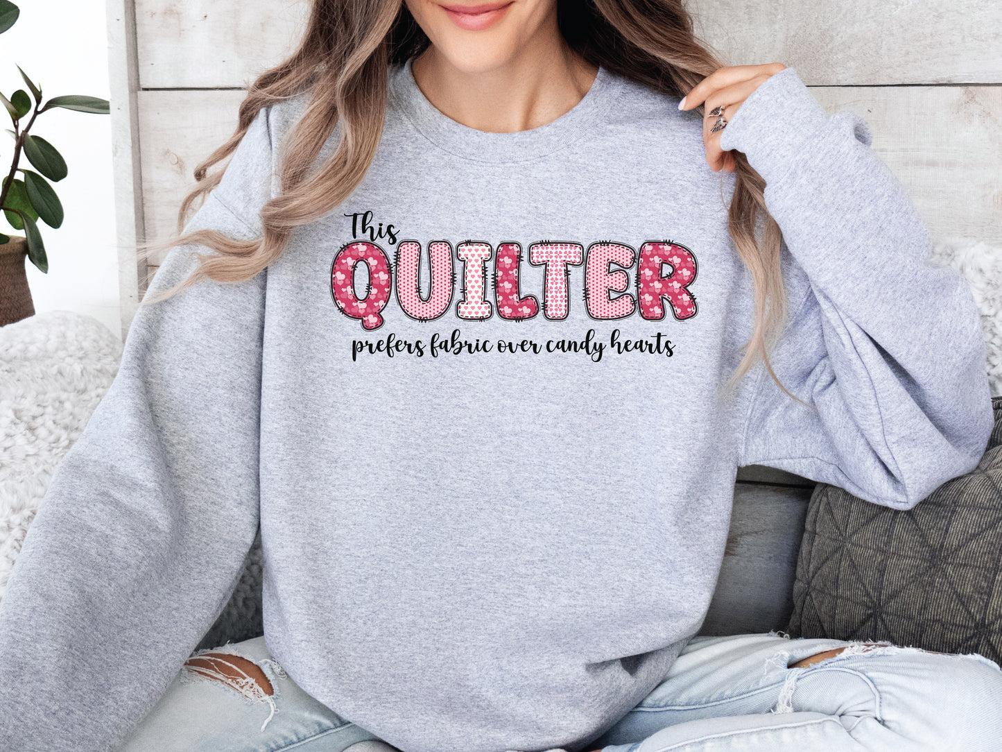 Valentine’s Day quilting t-shirt with the phrase “This Quilter Prefers Fabric Over Candy” in patchwork-style lettering, perfect for quilters.