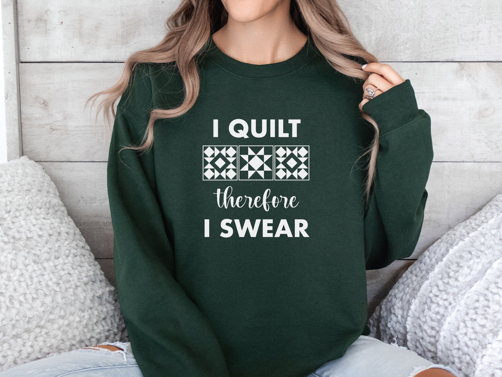 A cozy quilting sweatshirt from Bee Inspired Tees featuring the phrase “I Quilt, Therefore I Swear,” a funny and relatable gift for quilters who love to sew, laugh, and stay warm while stitching.