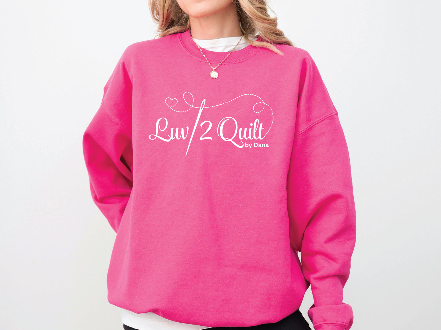 Official Luv2Quilt by Dana quilting-themed sweatshirt featuring the Luv2Quilt logo with a sewing needle and stitched heart design, perfect for quilt classes, retreats, and everyday wear.