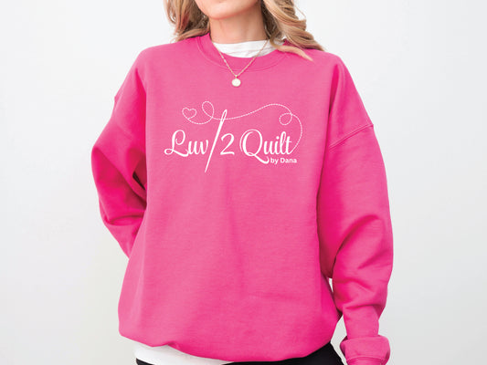 Official Luv2Quilt by Dana quilting-themed sweatshirt featuring the Luv2Quilt logo with a sewing needle and stitched heart design, perfect for quilt classes, retreats, and everyday wear.